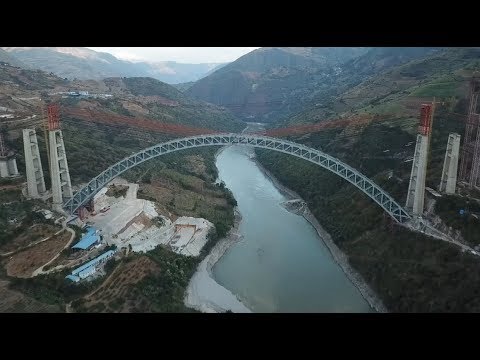 Steel Truss Arch of Four-lane Railway Bridge Linked up in China newspaper mockup