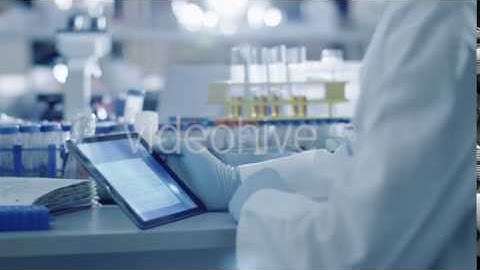 Senior Scientist is Using a Tablet in a Laboratory - Stock Footage | VideoHive 14135006