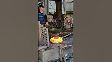 Forging high-temperature square iron blocks into circular iron cakes before drilling