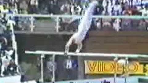 parallel bars.roll backward to handstand