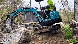 Making a stonewall and a walkway with the miniexcavator