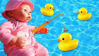 Baby Annabell doll goes for a walk to the beach. Baby doll plays with a toy duck for babies.