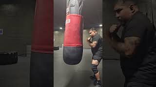 Powerlifting manlet hits punching bag