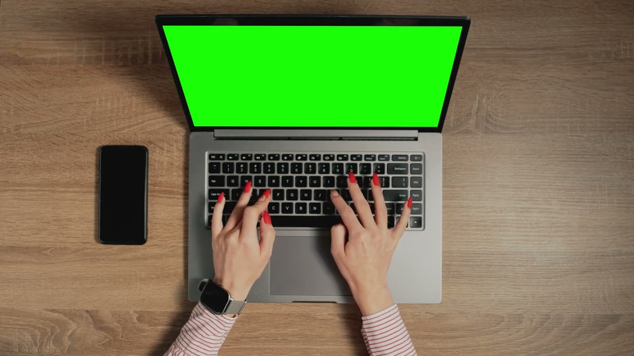 hands typing on a keyboard with a  laptop / GREEN SCREEN /Royal music