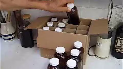 Amber 16 ounce beverage bottles with new tops for juice storage