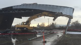 2 Caterpillar excavators bring down an airplane hanger