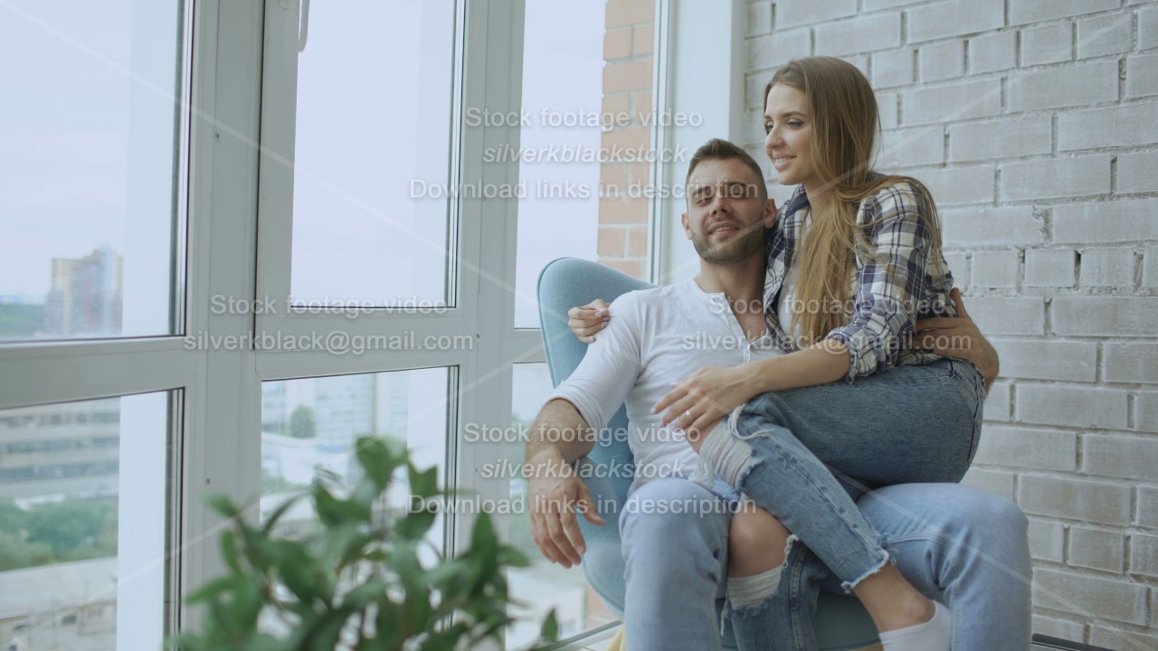 Beautiful young couple relax sitting on chair and enjoying view from