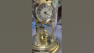 JUF anniversary clock with arrow pendulum