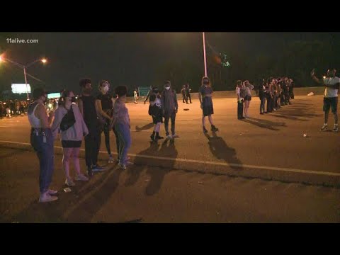 Line of white people form barrier on Atlanta interstate during protest
