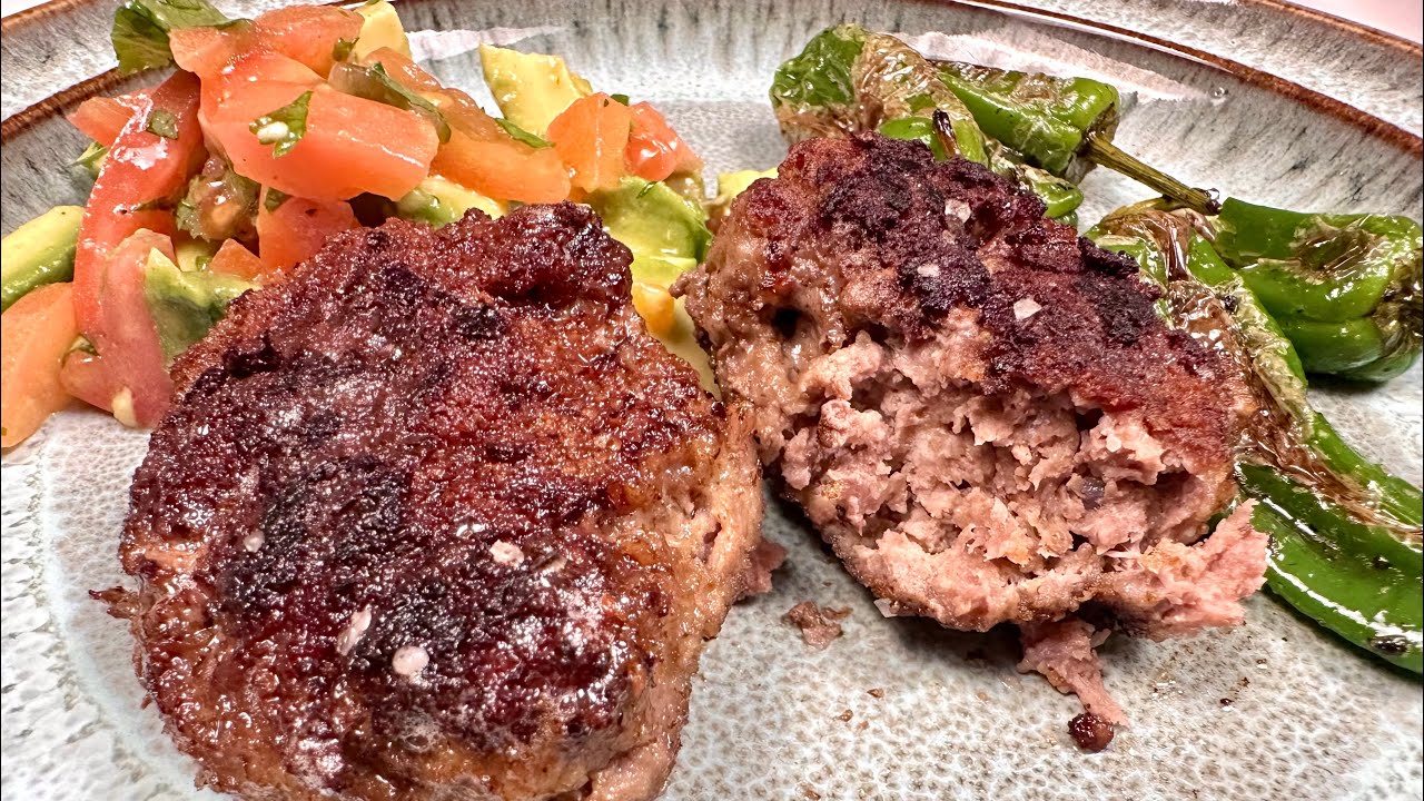Beef patties with avocado tomato salad