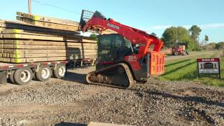 Skid steer unloading 144 sq. ft. of mats at a time.