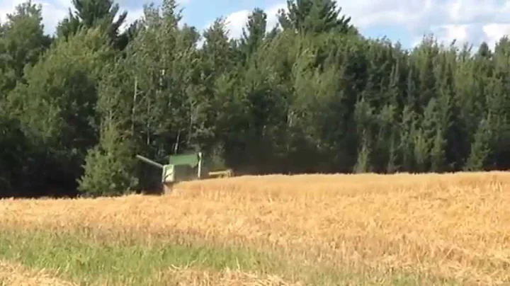 JD model 42 combine pulled by 1952 Farmall Super M