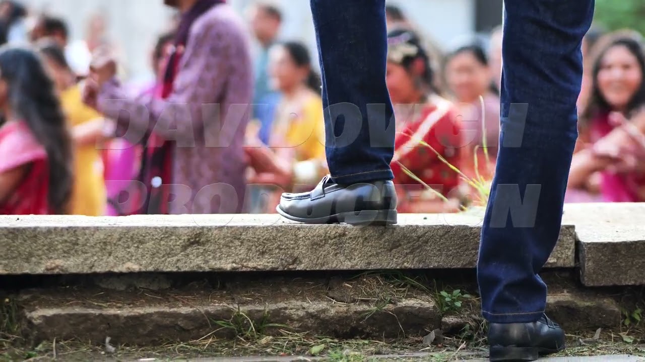 Man dancing at Ganesh Chaturthi festival, celebrating with friends in a vibrant crowd