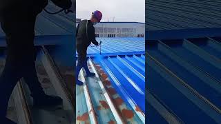 Spraying Anti-Rust Paint on Metal Roof