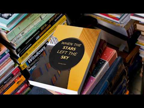 eBook Video Mockup of a Book Lying on a Pile of Different Books