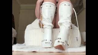 Unzipping White Stiletto Boots Slowly To Reveal Shimmering Tan Nylons On Plush Carpet