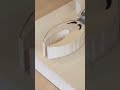 A piece of wood that is being scraped using a special sharp tool