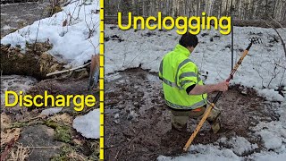 Unclogging Culvert Releasing Large Load Of Slop Into The River