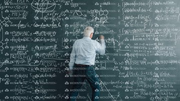 Zoom-in time lapse of senior man scientist writing calculations on blackboard