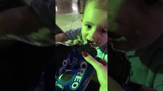 Woman puts Oreo cookies near little boy but before he can take a bite a fork with food goes in mouth