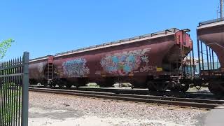 BNSF 6533 leads a WB grain train at Loula St in Olathe, KS