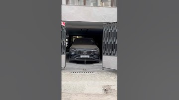 Remote-operated bi-fold swing gate motor system.