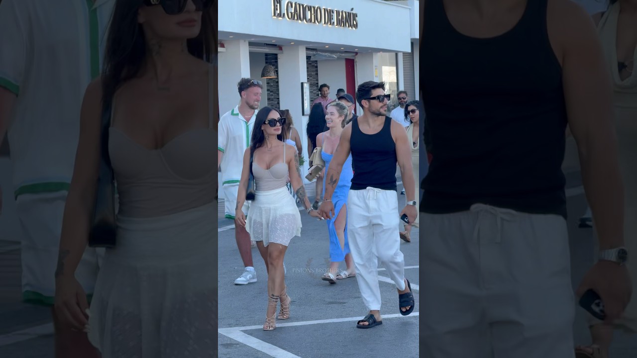 Lovely rich couple walking through Puerto Banus 