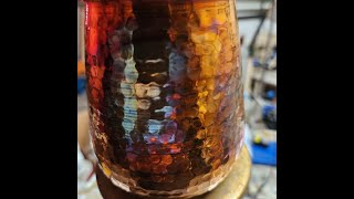 Annealing Copper cups with propane to give rainbow color patterns.