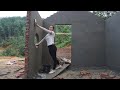 Lonely 20 year old girl building bricks house  apply the cement coat to the wall  build new house