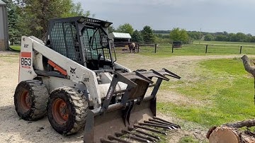 863 Bobcat skid steer with grapple attachment | Belted Galloway Homestead