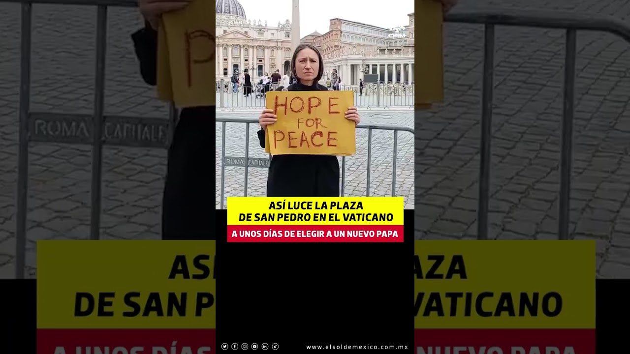Yona Tukuser holds a "HOPE FOR PEACE" sign in St. Peter's Square at the Vatican during the Conclave