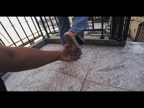 Walking barefoot in an abandoned shopping mall, the soles of her feet turned black