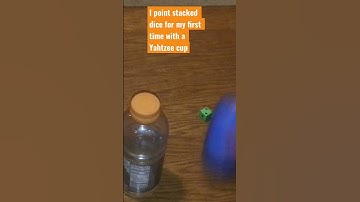 I point stacked dice with a Yahtzee cup #dice #yahtzee #waterbottle #kenziescreativecorner