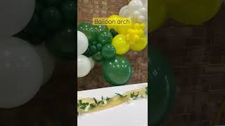 White yellow and green balloon arch from SweeTease Tables