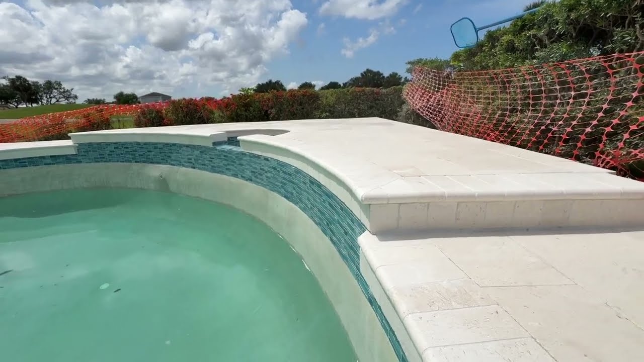 Transforming Backyard Luxury: New Shell Stone Pool Deck + Waterline Tile Installation
