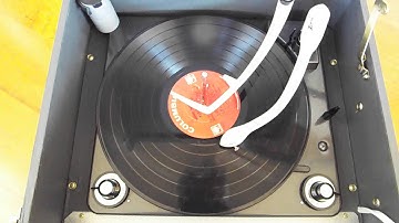 Zenith Cobramatic Tube amplified record player playing a LP record