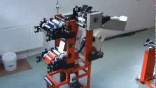 Machine for flexo printing and cutting the labels to the bottom of the bags