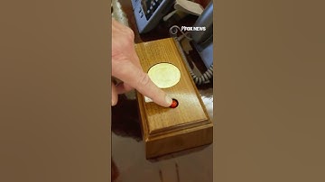 Trump shows off the coke button on his desk in the oval office