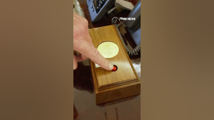 Trump shows off the coke button on his desk in the oval office