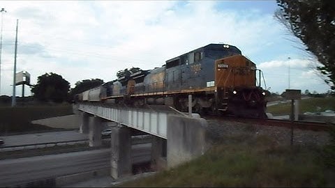 CSX Train Over A Bridge And Through A Crossing To The Railroad Yard We Go