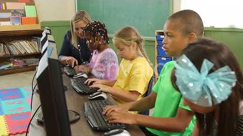 Teacher and students working on computers in school classroom | Stock Footage - Envato elements