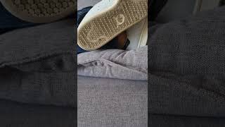 Dirty Adidas Stan Smith With No Socks Relaxing On The Couch.