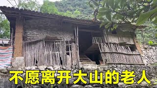 The small mountain village was demolished by the government. The old man did not want to leave and