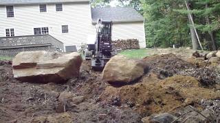 Bobcat E50 Moving Two Huge Rocks