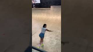 Girl on roller skates rides around half pipe and faceplants at skatepark