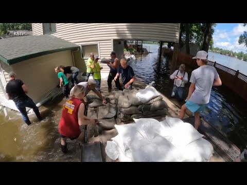 ‘Catastrophic flooding’ in Upper Midwest prompts evacuations as record-breaking heat broils
