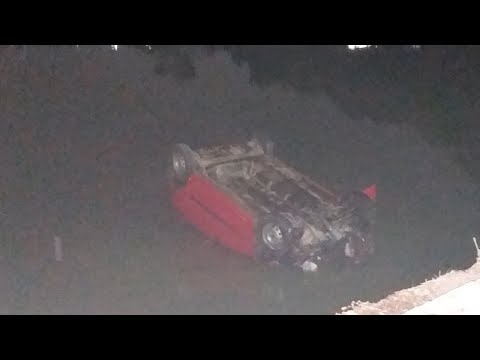 Over speeding car falls in Hussain Sagar | 4 students miraculously escaped with minor injuries