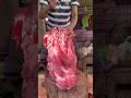 The cow's throat is being cut.