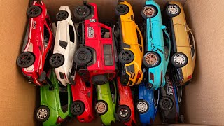 Collecting model cars from box, Lamborghini, camaro, porsche, volkswagen, honda fit.