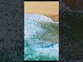 Aerial Ocean Waves Meeting Golden Sandy Shore
